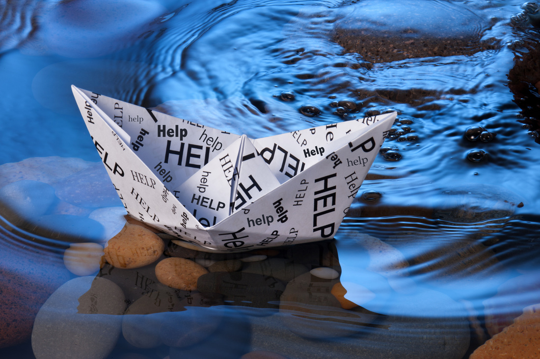 Crisis management image. Paper boat adrift in water with help written on it.   