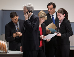 Crisis management. Image of a team of people busy on phones and in meetings